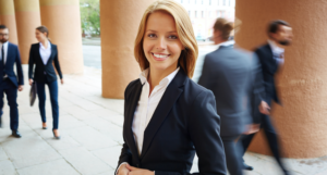 women in a business suit smiling 