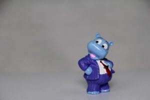 blue animal figurine wearing a work suit 